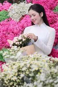 VGU No.147: Discover the enchanting grace of a Vietnamese girl in traditional Ao Dai amidst a vibrant flower market - image 2