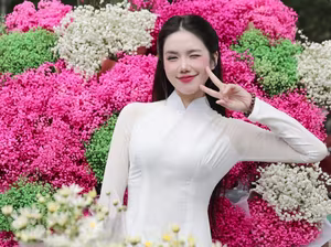 VGU No.147: Discover the enchanting grace of a Vietnamese girl in traditional Ao Dai amidst a vibrant flower market - image 4