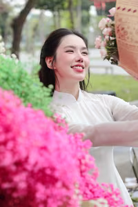 VGU No.147: Discover the enchanting grace of a Vietnamese girl in traditional Ao Dai amidst a vibrant flower market - image 6