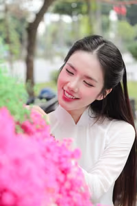 VGU No.147: Discover the enchanting grace of a Vietnamese girl in traditional Ao Dai amidst a vibrant flower market - image 3
