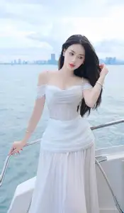 Elegant Beauty on the Waves: White Dress Muse Cruises the Azure Sea - image 1