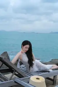 Elegant Beauty on the Waves: White Dress Muse Cruises the Azure Sea - image 0