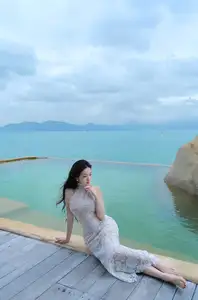 Elegant Beauty on the Waves: White Dress Muse Cruises the Azure Sea - image 4