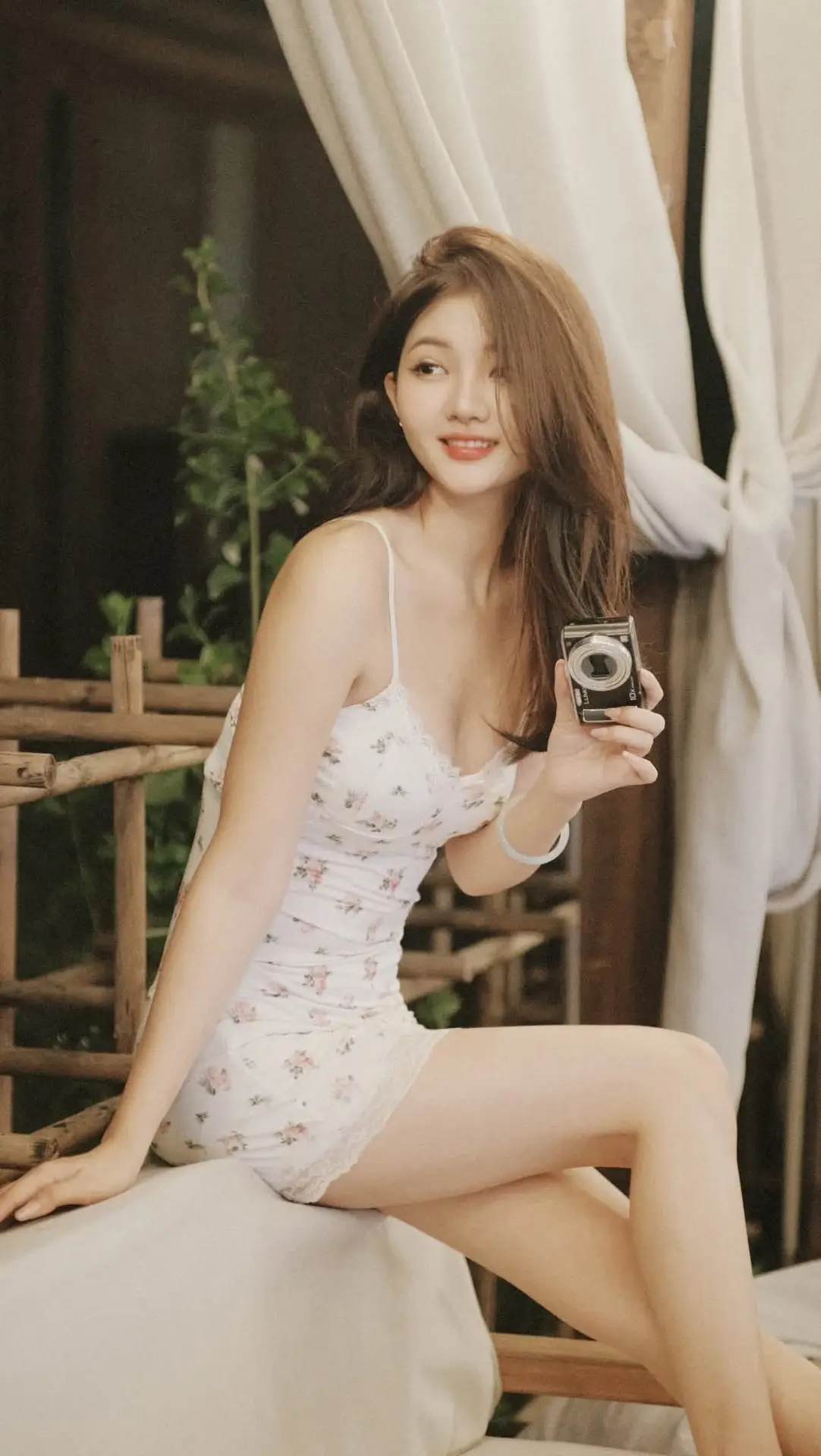 Captivating East Asian Beauty in Floral Slip Dress with Vintage Camera