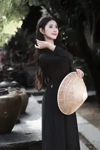 Timeless Beauty: Graceful Vietnamese Lady in Black Ao Dai Captivates with Asian Elegance. - image 1