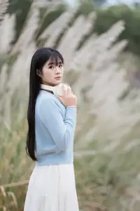 Explore Serene Beauty: Long-Haired Girl Immersed in Music Amidst Pampas Grass - image 0