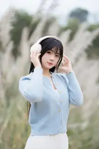 Explore Serene Beauty: Long-Haired Girl Immersed in Music Amidst Pampas Grass - image 9