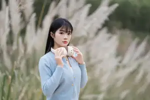 Explore Serene Beauty: Long-Haired Girl Immersed in Music Amidst Pampas Grass - image 6