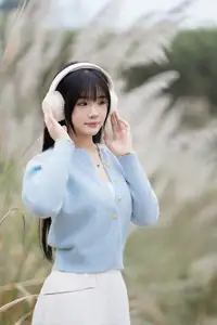 Explore Serene Beauty: Long-Haired Girl Immersed in Music Amidst Pampas Grass - image 3