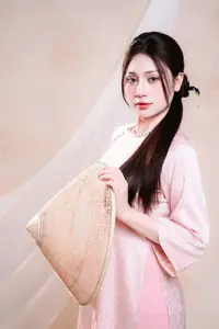 Vietnamese Beauty: Graceful in Traditional Pink Ao Dai and Conical Hat - image 0