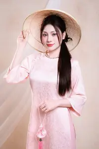 Vietnamese Beauty: Graceful in Traditional Pink Ao Dai and Conical Hat - image 4