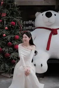 Elegant Girl in Off-Shoulder White Dress Welcoming Christmas, Showcasing Gentle Beauty and Holiday Season Style. 1000027390 - image 1