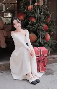 Elegant Girl in Off-Shoulder White Dress Welcoming Christmas, Showcasing Gentle Beauty and Holiday Season Style. 1000027390 - image 7