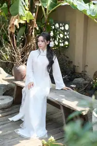 Elegant White Ao Dai: Pure Beauty of Vietnamese Woman with Pristine Orchids. - image 5