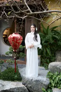 Elegant White Ao Dai: Pure Beauty of Vietnamese Woman with Pristine Orchids. - image 12