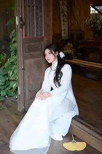 Elegant White Ao Dai: Pure Beauty of Vietnamese Woman with Pristine Orchids. - image 1