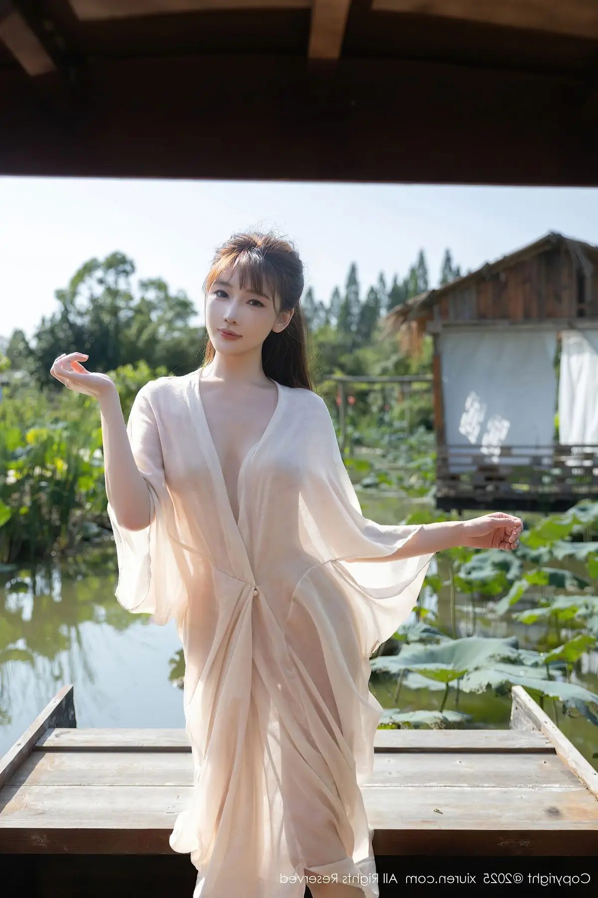 Discover Lu Xuan Xuan's Graceful Beauty in a White Dress Amidst a Serene Lotus Pond - XiuRen No.10630