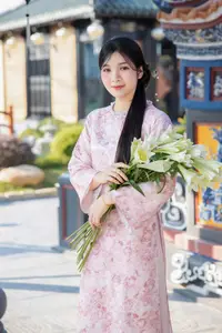 Graceful Asian Lady in Pink Ao Dai with Pristine White Lilies in Traditional Setting - image 3
