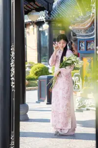 Graceful Asian Lady in Pink Ao Dai with Pristine White Lilies in Traditional Setting - image 4
