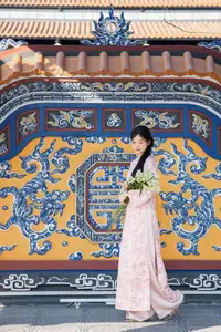 Graceful Asian Lady in Pink Ao Dai with Pristine White Lilies in Traditional Setting - image 1