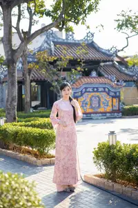 Graceful Asian Lady in Pink Ao Dai with Pristine White Lilies in Traditional Setting - image 5
