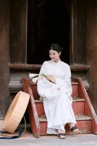 Graceful Vietnamese Beauty: A Serene Woman in White with a Lily - image 1