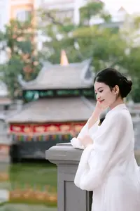 Graceful Vietnamese Beauty: A Serene Woman in White with a Lily - image 4