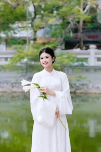 Graceful Vietnamese Beauty: A Serene Woman in White with a Lily - image 2