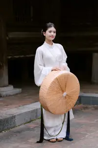 Graceful Vietnamese Beauty: A Serene Woman in White with a Lily - image 3