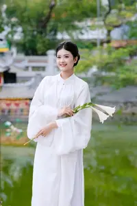 Graceful Vietnamese Beauty: A Serene Woman in White with a Lily - image 6