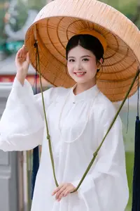 Graceful Vietnamese Beauty: A Serene Woman in White with a Lily - image 0