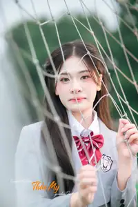 Cute Schoolgirl Frames a Moment on Green Grass - image 0