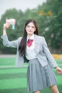 Cute Schoolgirl Frames a Moment on Green Grass - image 7