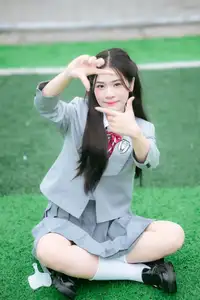 Cute Schoolgirl Frames a Moment on Green Grass - image 2