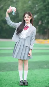 Cute Schoolgirl Frames a Moment on Green Grass - image 8