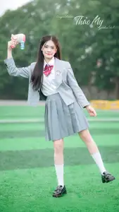 Cute Schoolgirl Frames a Moment on Green Grass - image 4