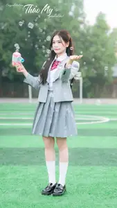 Cute Schoolgirl Frames a Moment on Green Grass - image 1