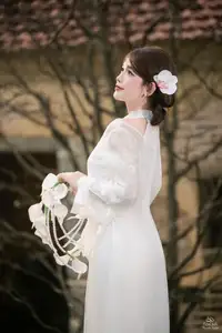Elegant Asian Beauty: A Gentle Girl Adorned with a Pure White Orchid - image 7