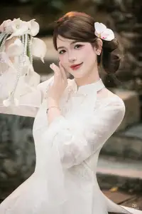 Elegant Asian Beauty: A Gentle Girl Adorned with a Pure White Orchid - image 0