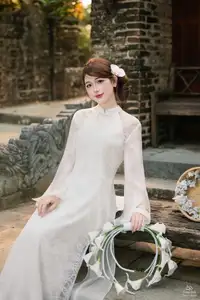 Elegant Asian Beauty: A Gentle Girl Adorned with a Pure White Orchid - image 2
