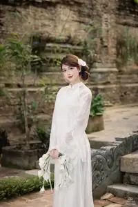 Elegant Asian Beauty: A Gentle Girl Adorned with a Pure White Orchid - image 1