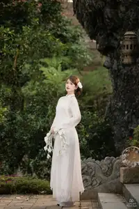 Elegant Asian Beauty: A Gentle Girl Adorned with a Pure White Orchid - image 5