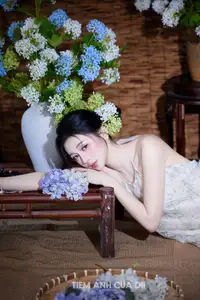 Ethereal Vietnamese Beauty: Graceful Asian Girl in Modern Yếm with Delicate Blooms. - image 1