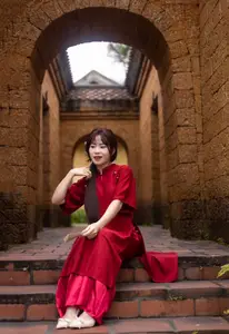 Discover the Timeless Elegance of a Vietnamese Woman in Red Ao Dai at Ancient Architecture. - image 4