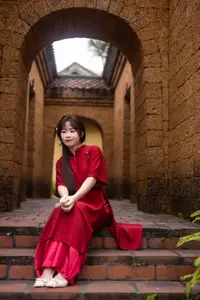 Discover the Timeless Elegance of a Vietnamese Woman in Red Ao Dai at Ancient Architecture. - image 0