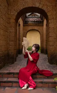 Discover the Timeless Elegance of a Vietnamese Woman in Red Ao Dai at Ancient Architecture. - image 9