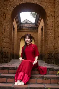 Discover the Timeless Elegance of a Vietnamese Woman in Red Ao Dai at Ancient Architecture. - image 1