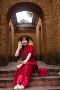 Discover the Timeless Elegance of a Vietnamese Woman in Red Ao Dai at Ancient Architecture. - image 3