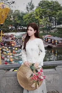 Elegant Vietnamese Beauty in White Ao Dai Serene Portrait with Pink Lilies on Ancient Stone Steps - image 3