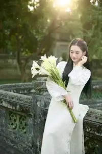 Graceful Vietnamese Woman in Ao Dai Amidst Ancient Architecture - image 1